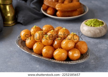 Traditional middle eastern  fried sweets lokma, awameh,  luqaimat. Ramadan dessert . Closeup                             Royalty-Free Stock Photo #2252185657