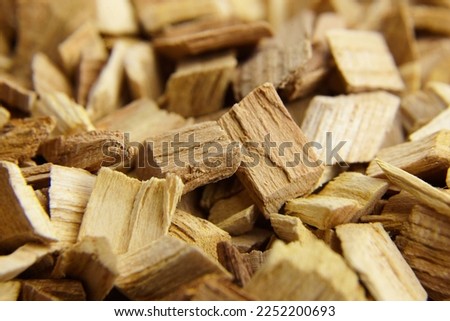 Wood chips for smocking texture background. Natural apricot wood smoking chunks Royalty-Free Stock Photo #2252200693