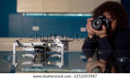 Real estate photographer takes photos and video inside house with professional camera and drone - technology to sell home - real estate agency and photograph shooting - home staging 