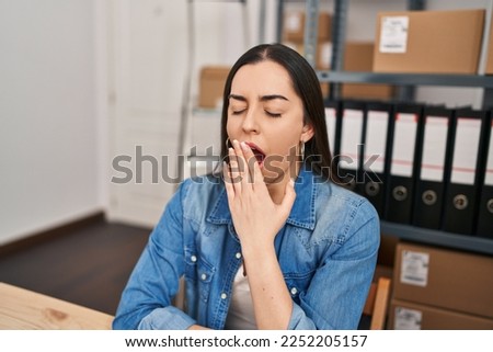 Young beautiful hispanic woman ecommerce business worker stressed using laptop at office