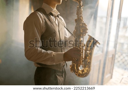 Saxophone player foggy toned cropped shot Royalty-Free Stock Photo #2252213669