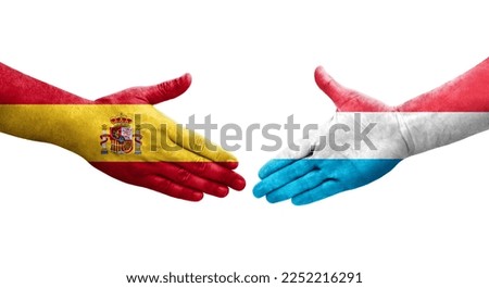 Handshake between Luxembourg and Spain flags painted on hands, isolated transparent image.