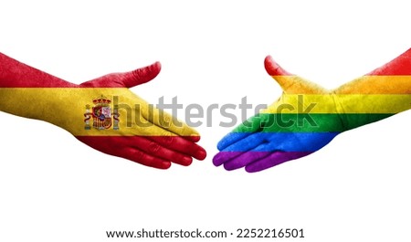 Handshake between LGBT and Spain flags painted on hands, isolated transparent image.