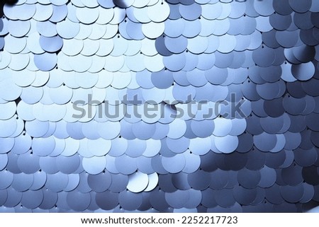 Texture of beautiful silver sequins as background, top view