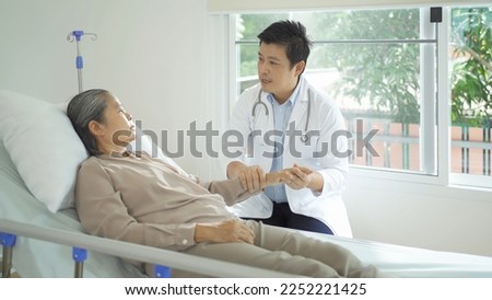 Portrait of Asian doctor check up body of sick old senior elderly patient on bed in hospital in medical and healthcare treatment at nursing home. People lifestyle