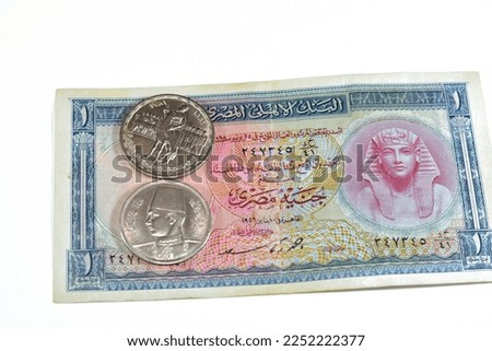 Background of old Egyptian money banknotes and coins of One Egyptian pound 1 EGP LE banknote bill of king Tutankhamen and coin of Orabi Revolution and 10 ten Egyptian piasters of king Farouk I  First