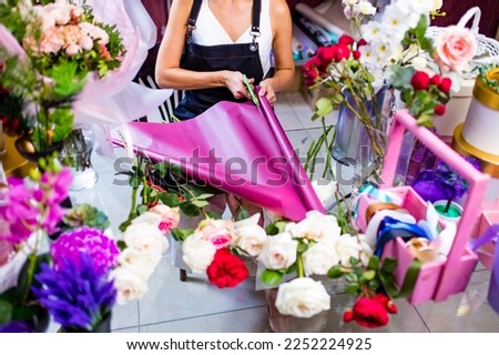 Cropped view of florist making flower bouquet close up
