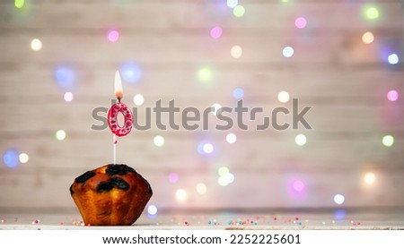 Happy birthday background with muffin and number of candles on light bulbs bokeh background. Greeting card happy birthday copy space with number 0