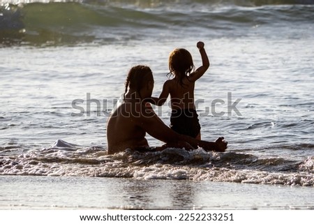 Father and little son waiting for wave