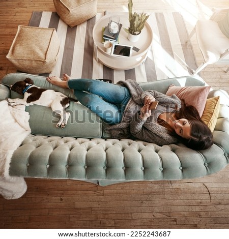 Woman relax on couch with phone, social media scroll and communication at home, contact and technology. Happy woman, smile for meme and web search with streaming, smartphone and rest on sofa top view