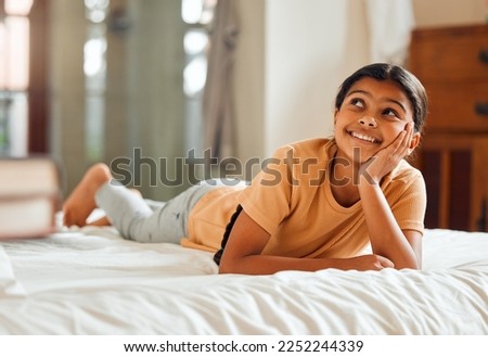 Fantasy, bed and black girl thinking, ideas and relax on weekend, happiness and summer break. African American female child, young lady or daydreaming, imagination and thought with wonder and bedroom Royalty-Free Stock Photo #2252244339