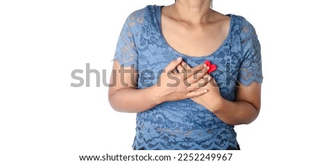 Woman holding hands at heart on white background.Health care concept.
