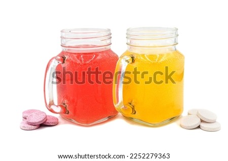 Effervescent tablets in a glass of water close-up on an isolated background. Vitamin C tablet. Health concept.