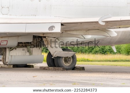 close up photos of older commercial jet landing gear parked at a bone yard.  
