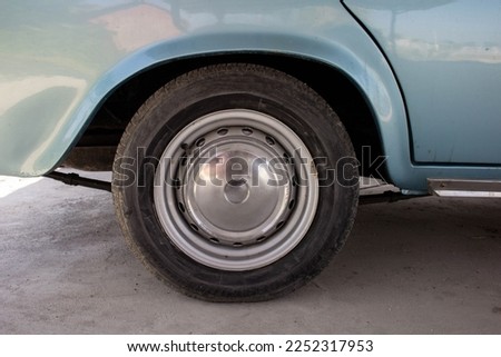 Close up of old american car's front wheel and rim.