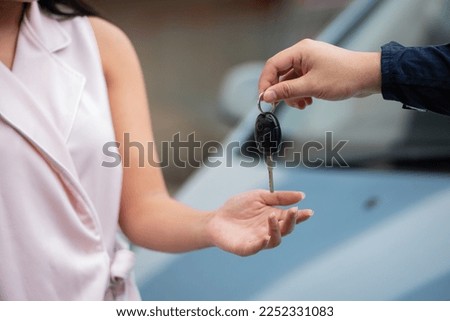 car salesman give key car to lender or buyer after making deal contract with lender. Used cars cheap than new car. used car must be examine before lender signing contract deal leasing. Royalty-Free Stock Photo #2252331083