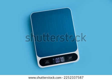 Electronic kitchen scales on a colored background Royalty-Free Stock Photo #2252337587