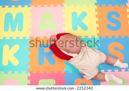 little baby on colorful floor cover