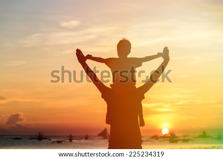 happy father and son on sunset beach vacation
