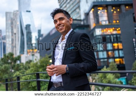 A portrait of a young Latin smiling, happy, successful business man Royalty-Free Stock Photo #2252346727