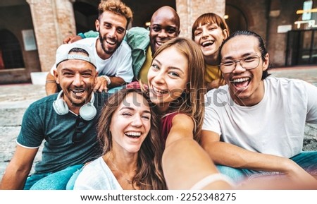 Multicultural friends taking selfie picture with smart mobile phone device outdoors - Group of young people smiling at camera - University students having fun in college campus - Youth culture