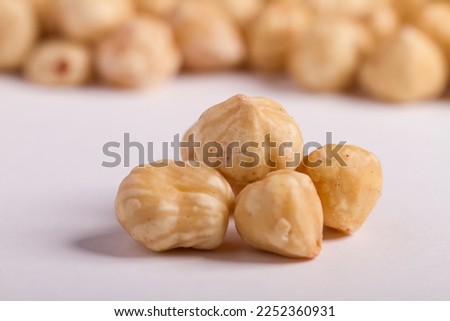 Close up on hazelnuts shot in a studio, no people are visible.