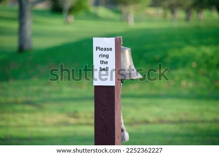 Ring the bell please sign on golf course