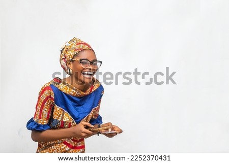copy space image of Young African woman holding phone and credit card laughing isolated over a white isolated background Royalty-Free Stock Photo #2252370431