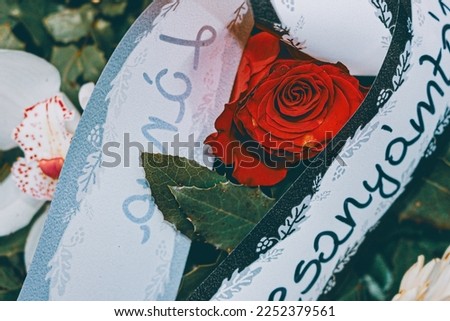 Flower arrangement with a rose. Still life photo. The writing says from my mother.