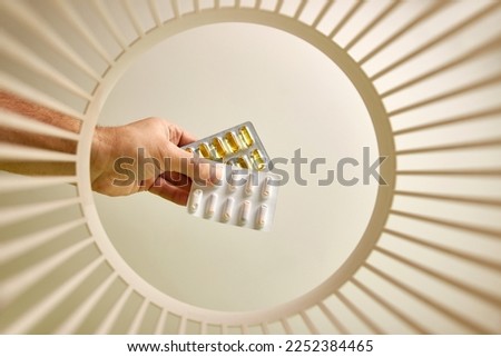 Expired pills are thrown away and recycled in the trash. View from below. The concept of disposal and recycling. Royalty-Free Stock Photo #2252384465