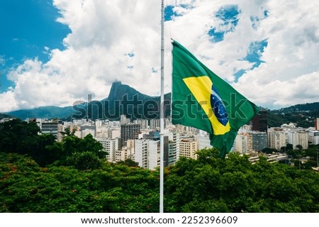Brazilian flag on the background of Christ the Redeemer, in Rio de Janeiro, Brazil Royalty-Free Stock Photo #2252396609