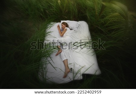 A hidden place. Sleeping woman in deep jungle forest lies on airbed
