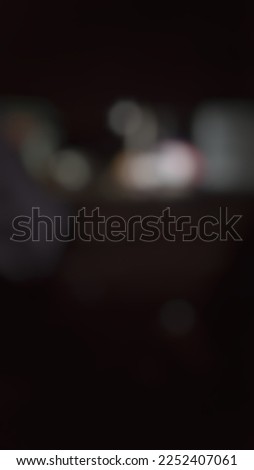 Blur photo of an atmosphere at night that looks dark with a portrait view.