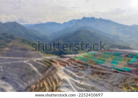 Blurred background of open pit mining. Aerial view of industrial slope on mineral mine site. Royalty-Free Stock Photo #2252410697