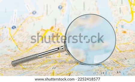 Abstract map through magnifying lens, glass. Geography, cartography, travel, tourism concept. High quality photo