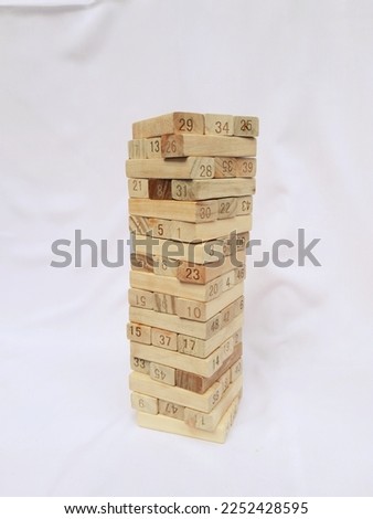 Wooden block stacks puzzle with number front view well arranged game education on white background