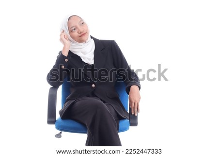 Cute young Asian hijab corporate girl with smooth glowing skin smiling and relaxing over an isolated background studio. Beauty skin care, office concept