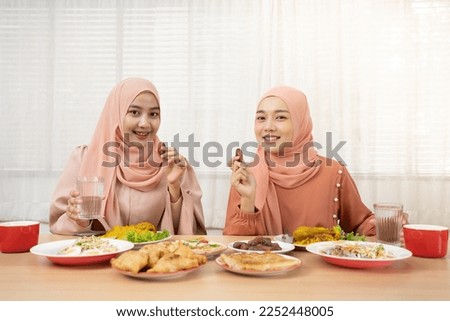 Asian Muslim family having dinner, Arabian family eating iftar in Ramadan.

Break fasting during Ramadan.

 Royalty-Free Stock Photo #2252448005