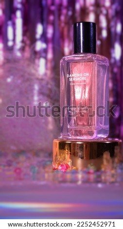 dancing on seashore perfume with pink neon background for  party night