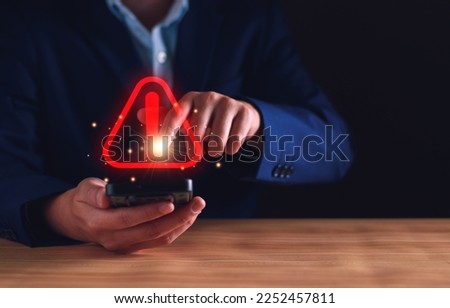 Businessman staff, programmer, developer using technology with triangle caution warning sign notification error and maintenance concept. System warning hacked alert, cyber attack on computer network.