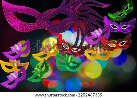 Carnival masks on a blurred colored background. Symbol of carnival, holiday. Place for text.