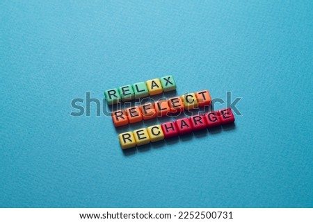 Relax reflect recharge - word concept on cubes, text, letters