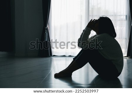 Concept of sad teenage girl depression. Upset teenage girl sitting at floor indoors. Anxiety young woman Despair and stress. Lonely and unhappy female are social victims. loneliness youth in home. Royalty-Free Stock Photo #2252503997