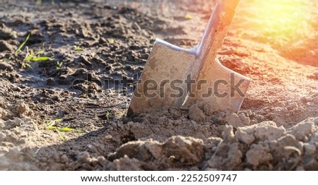 the shovel is stuck in the ground, the concept of infield painting and tillage. High quality photo