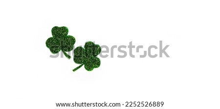 Happy St. Patrick's Day banner.Holiday background.St Patricks Day frame against a white background. Flat lay shamrocks.Copy space.Patrik's day banner Royalty-Free Stock Photo #2252526889
