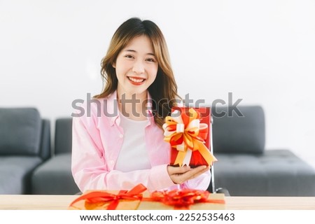 Happy smile young adult asian woman with red gift box. Holidays event christmas or valentine.