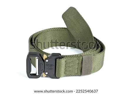 Green mens nylon fastening belt isolated on white background. Men's fashion outdoor military tactical belt.