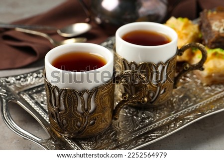 Tea served in vintage tea set on grey table, closeup