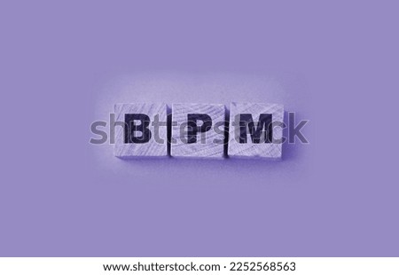 Acronym BPM - Business process management. Wooden small cubes with letters isolated on yellow background. Business Concept image Royalty-Free Stock Photo #2252568563