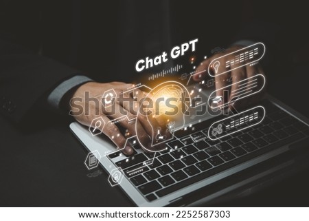 ChatGPT Chat with AI or Artificial Intelligence. Digital chatbot, robot application, OpenAI generate. Futuristic technology, Man using laptop computer on virtual screen. Royalty-Free Stock Photo #2252587303